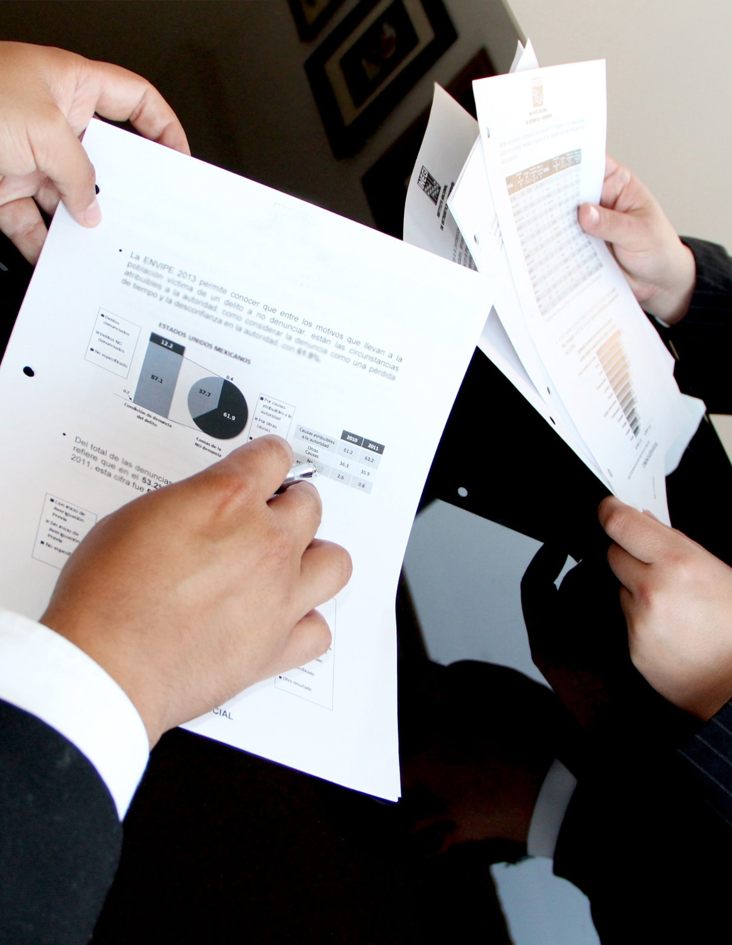 Two people reviewing printed analytics reports together